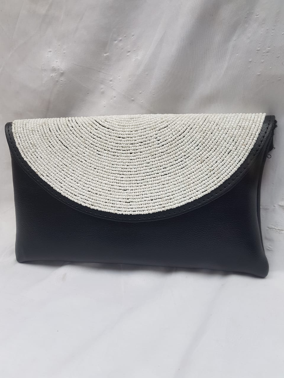 Leather clutch purse decorated with white beads