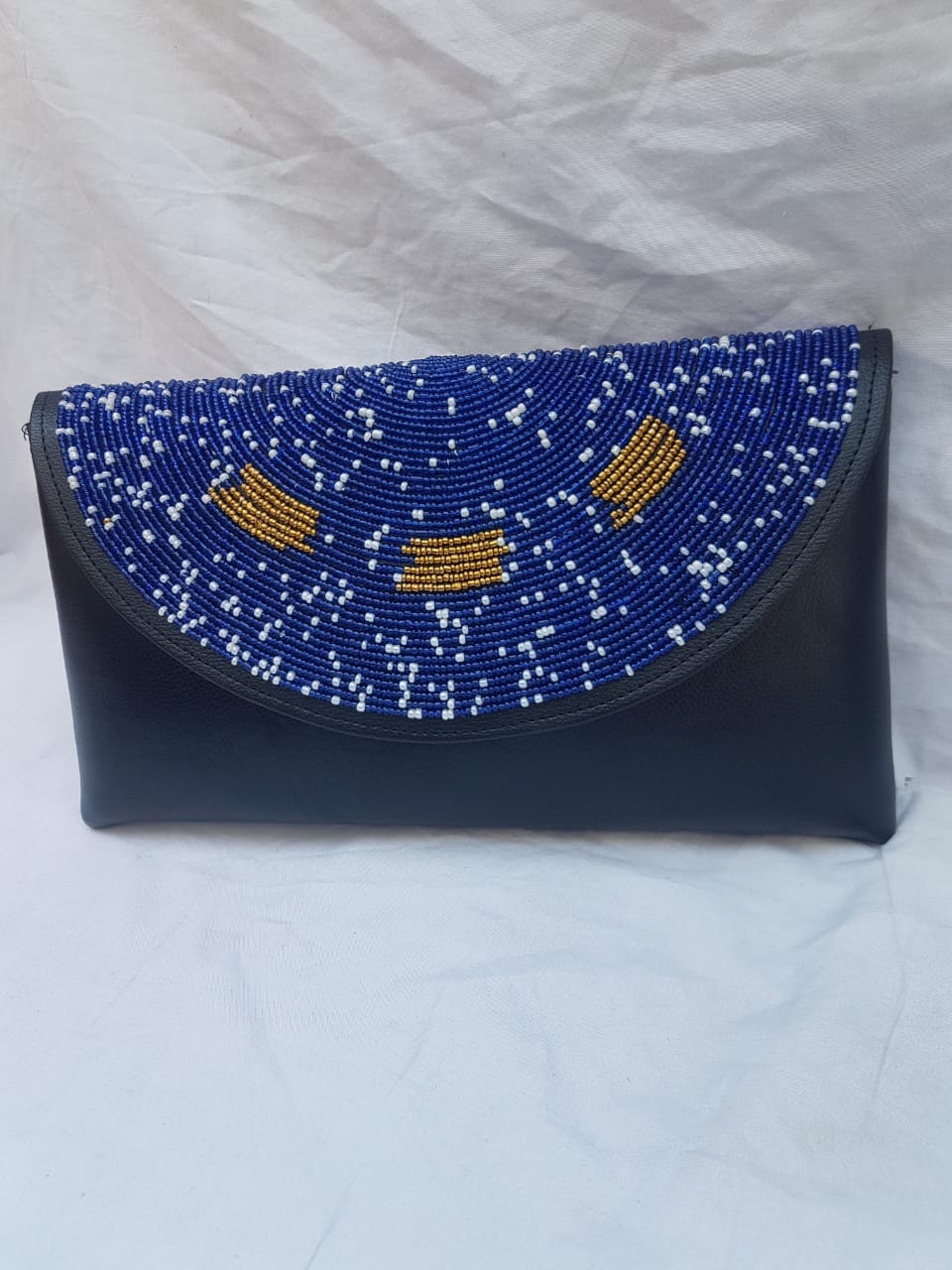 Leather clutch purse decorated with blue beads.