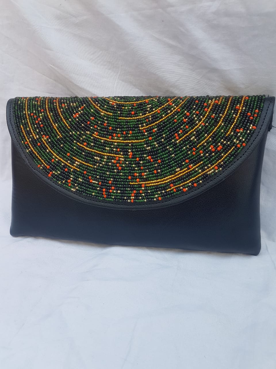 Leather clutch purse decorated with colorful beads.